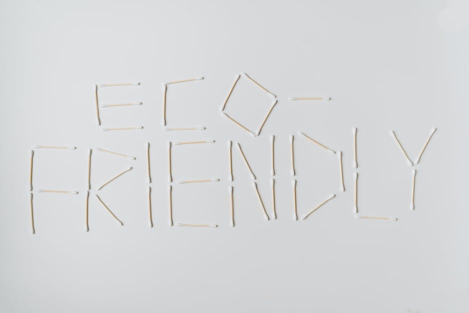 Cotton swabs spelling out "eco-friendly" on a clean white surface.