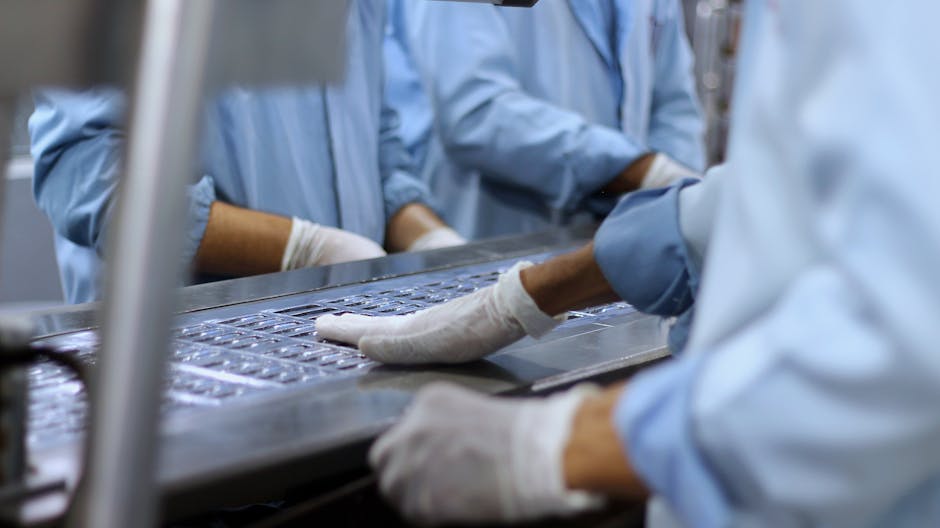 Workers in a pharmaceutical facility packaging tablets in Islamabad.