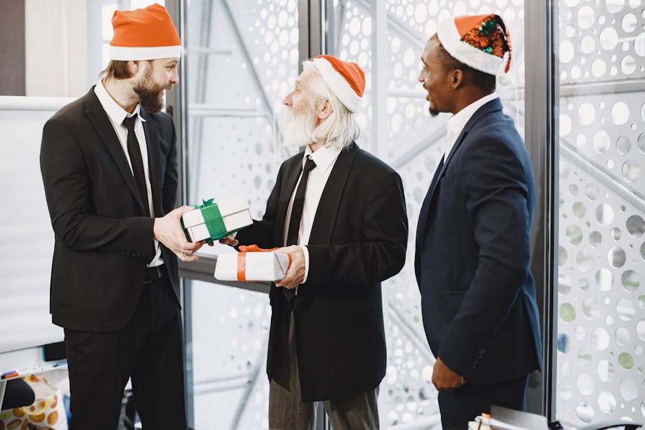 Three businessmen in Santa hats exchanging gifts in a festive office environment.